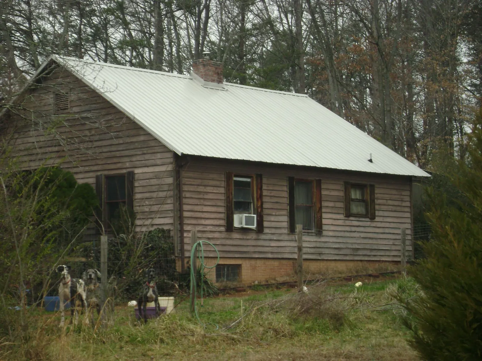 White metal roof on an old wood sided farmhouse, from a Metal Roof Installation job in Camanche